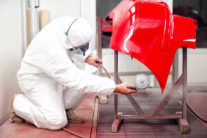 depositphotos_32117611-auto-mechanic-painting-with-spray-gun-bumper-of-car