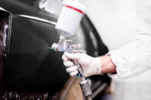depositphotos_36219861-worker-using-a-paint-spray-gun-for-painting-a-car