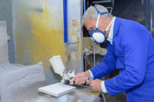 depositphotos_138951284-stock-photo-man-using-spray-paint-gun