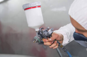 depositphotos_222880658-stock-photo-painter-spray-gun-hands-painter
