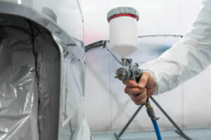 depositphotos_222881976-stock-photo-painter-spray-gun-hands-painter